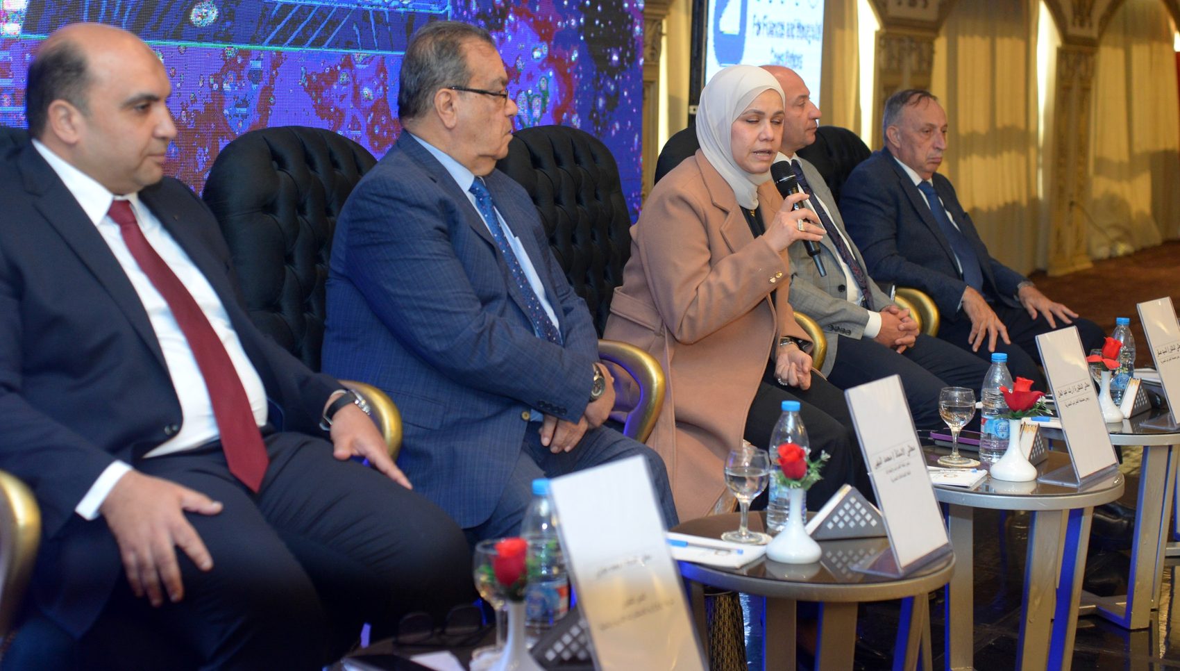 A speaker addressing the conference from the platform